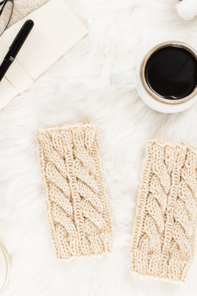 Worsted Cable Boot Cuffs laying on a faux fur blanket