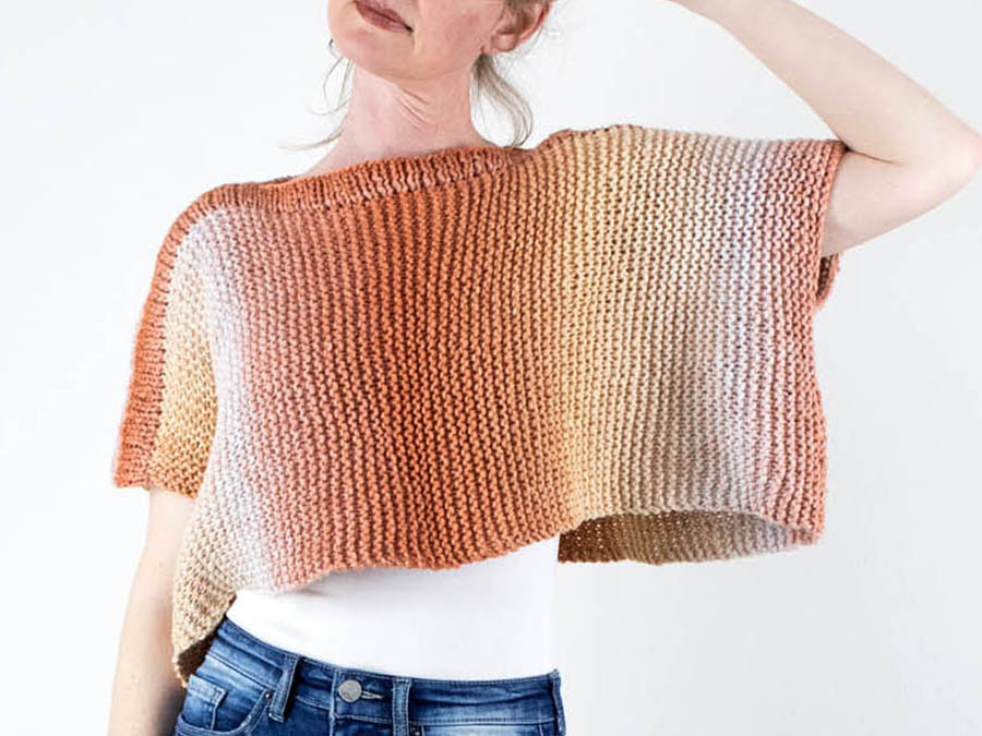 model wearing an easy poncho knitted in the garter stitch