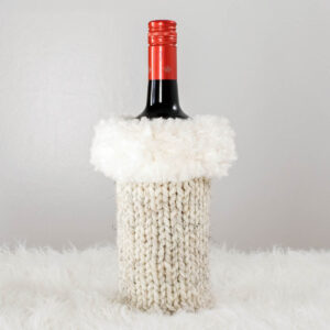 Christmas knitted wine bottle sweater displayed on a wine bottle.