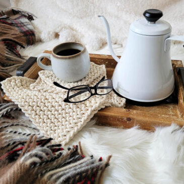 farmhouse knit potholders on a wooden tray, mug & coffee pot