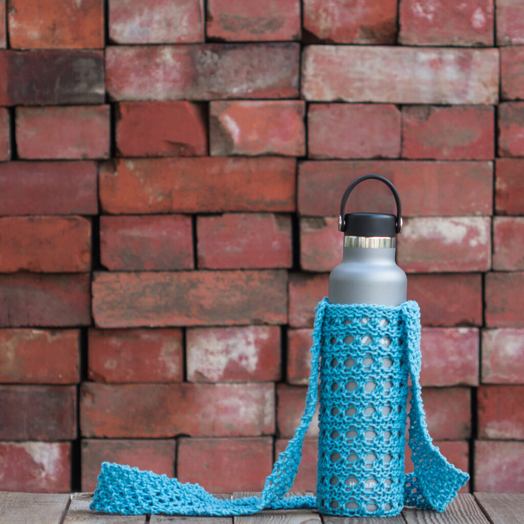 knitted water bottle holder displayed on a steel water bottle.