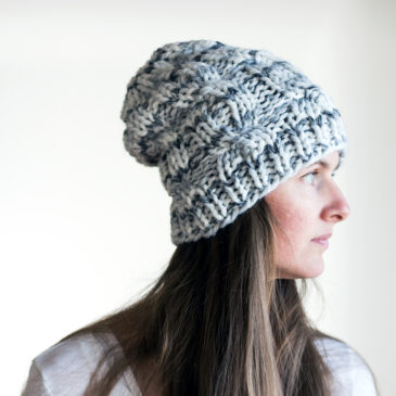 model wearing a cable knitted hat