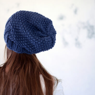 model wearing a knitted beanie hat