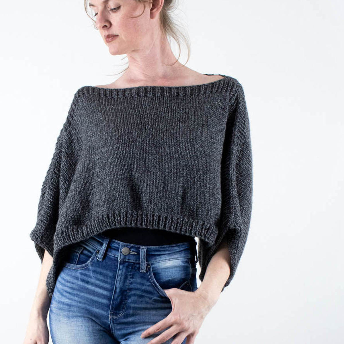 model wearing a hand knit rectangle poncho