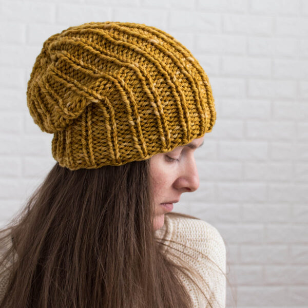 model wearing a simple slouchy knitted beanie hat